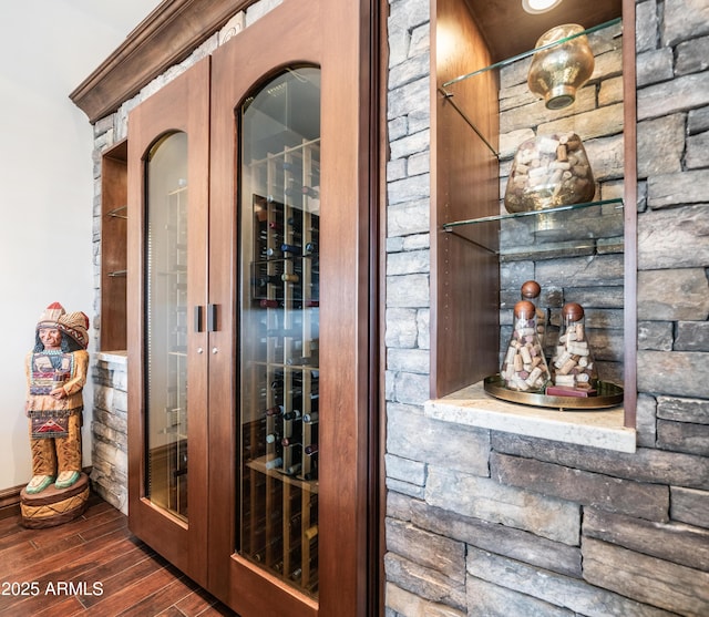 wine cellar with dark hardwood / wood-style flooring