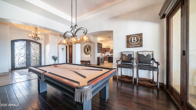 playroom featuring a tray ceiling, pool table, dark hardwood / wood-style flooring, and french doors