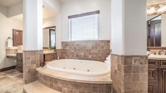 bathroom with vanity and a relaxing tiled tub