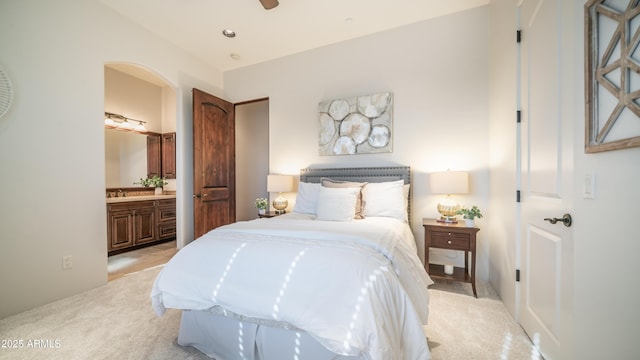 carpeted bedroom featuring ensuite bath