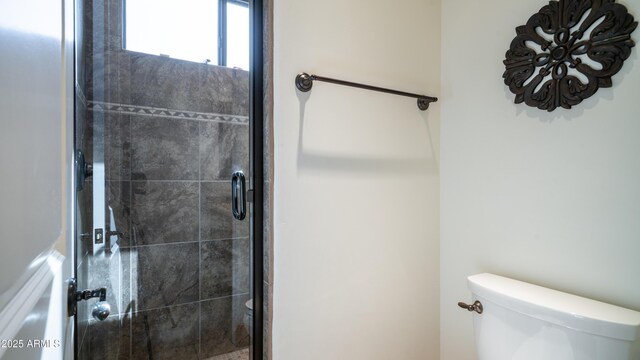 bathroom featuring toilet and walk in shower