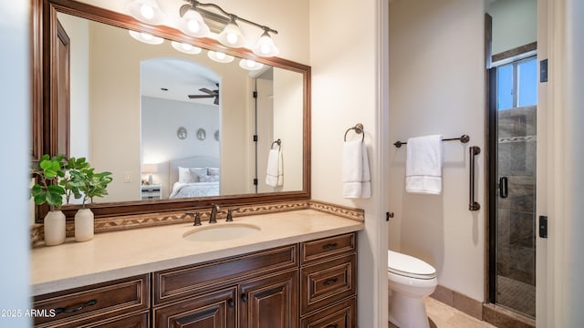 bathroom with vanity, a shower with shower door, ceiling fan, and toilet