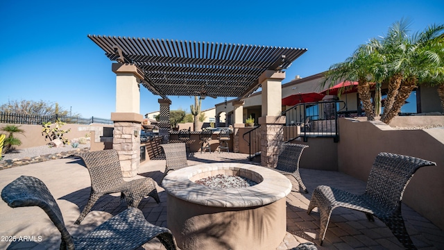 view of patio / terrace with a fire pit and a pergola