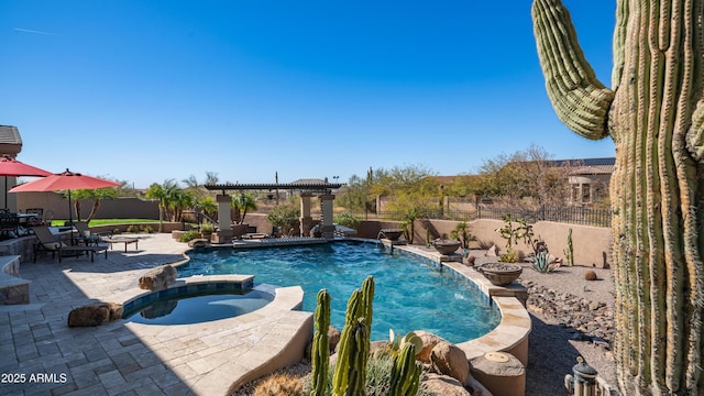 view of pool with an in ground hot tub, a patio, and a pergola