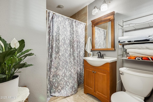 bathroom with a shower with curtain, vanity, toilet, and tile patterned flooring