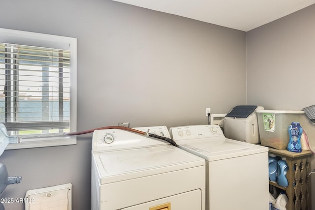 laundry room with a healthy amount of sunlight and washing machine and clothes dryer