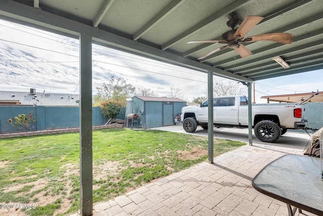 exterior space with ceiling fan and a storage unit