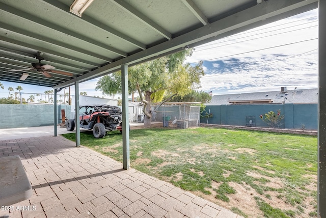 view of patio / terrace with ceiling fan and a storage unit