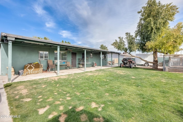 rear view of house with a yard and a patio