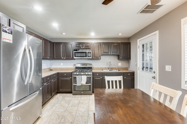 kitchen featuring dark brown cabinetry, stainless steel appliances, and sink