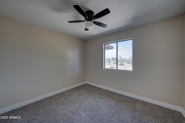 spare room featuring carpet flooring, baseboards, and a ceiling fan