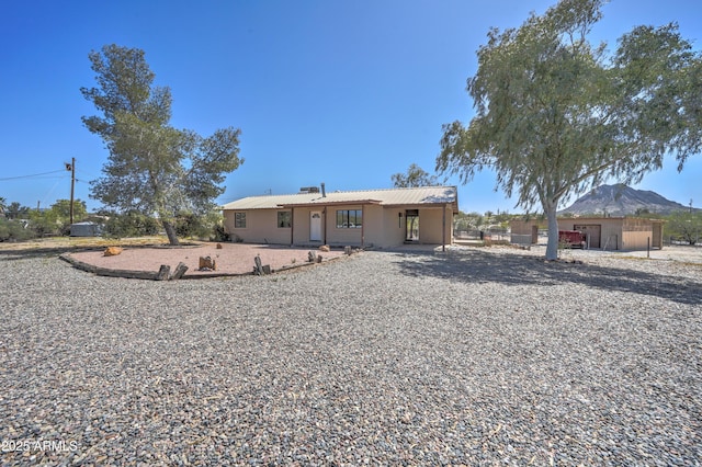 view of front of home with metal roof and a mountain view