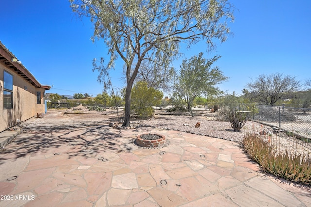 view of patio with a fenced backyard and a fire pit