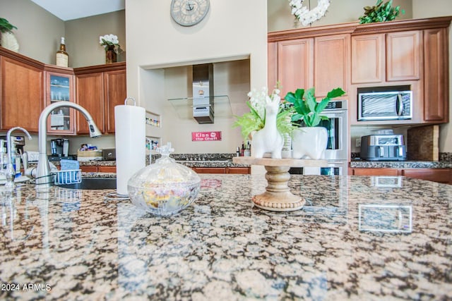 kitchen featuring stone counters and appliances with stainless steel finishes