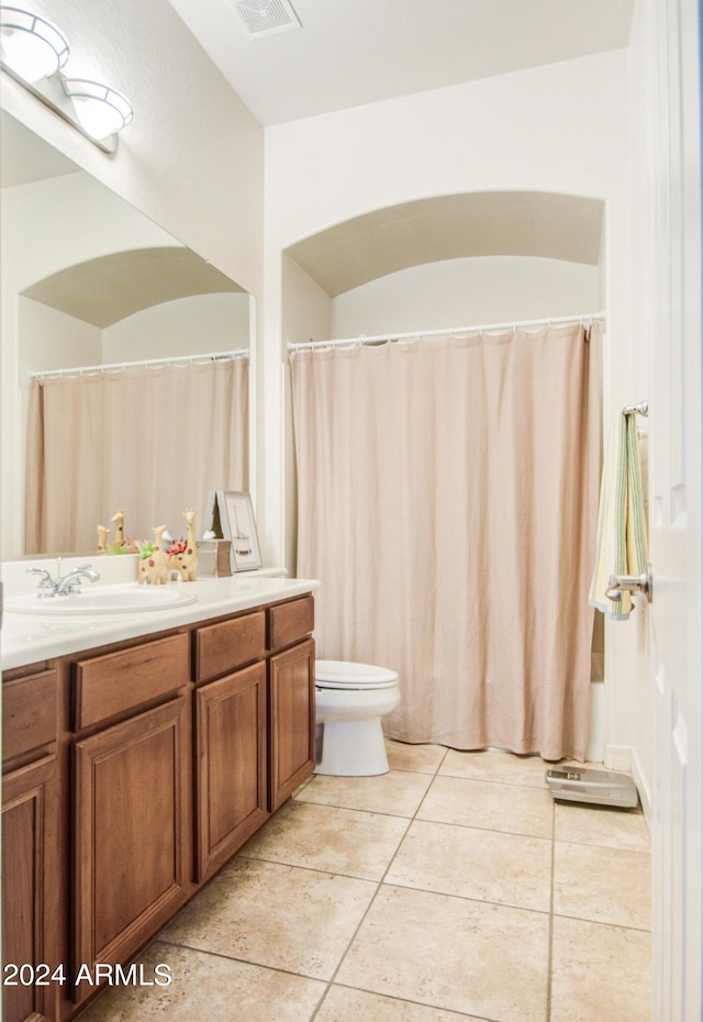 bathroom with vanity, toilet, and tile patterned flooring