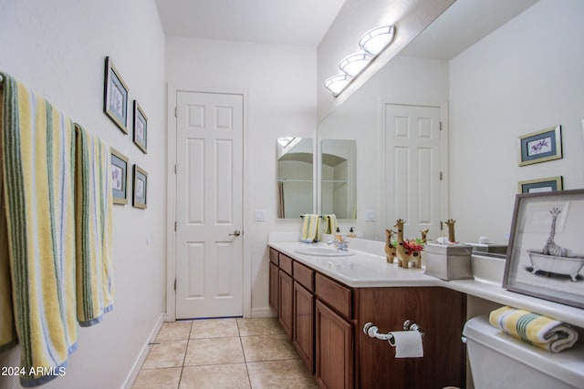 bathroom featuring tile patterned flooring, vanity, and toilet