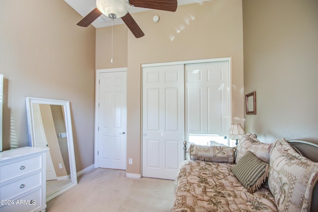 bedroom with light carpet, high vaulted ceiling, a closet, and ceiling fan