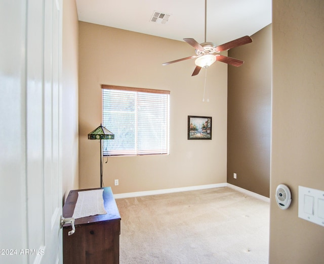 interior space featuring ceiling fan and light carpet