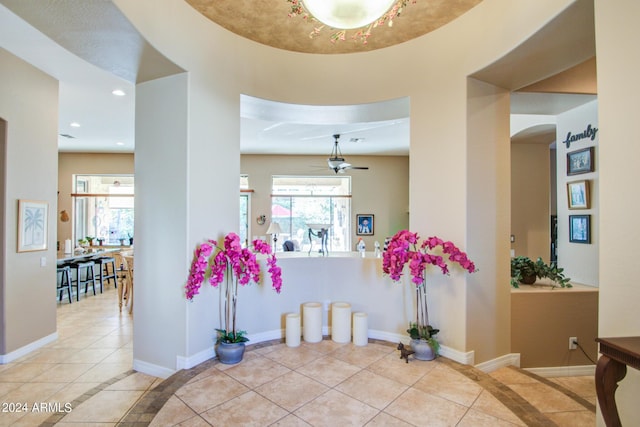 entryway with light tile patterned flooring and ceiling fan