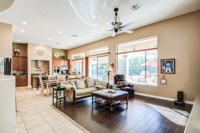 living room with ceiling fan and light wood-type flooring