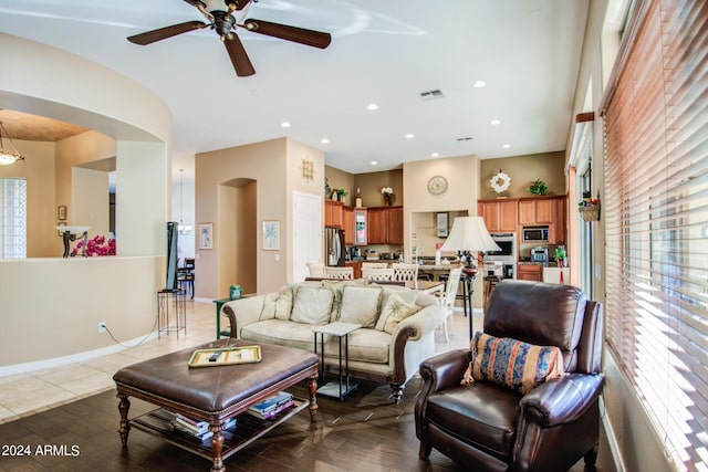 tiled living room featuring ceiling fan and a healthy amount of sunlight