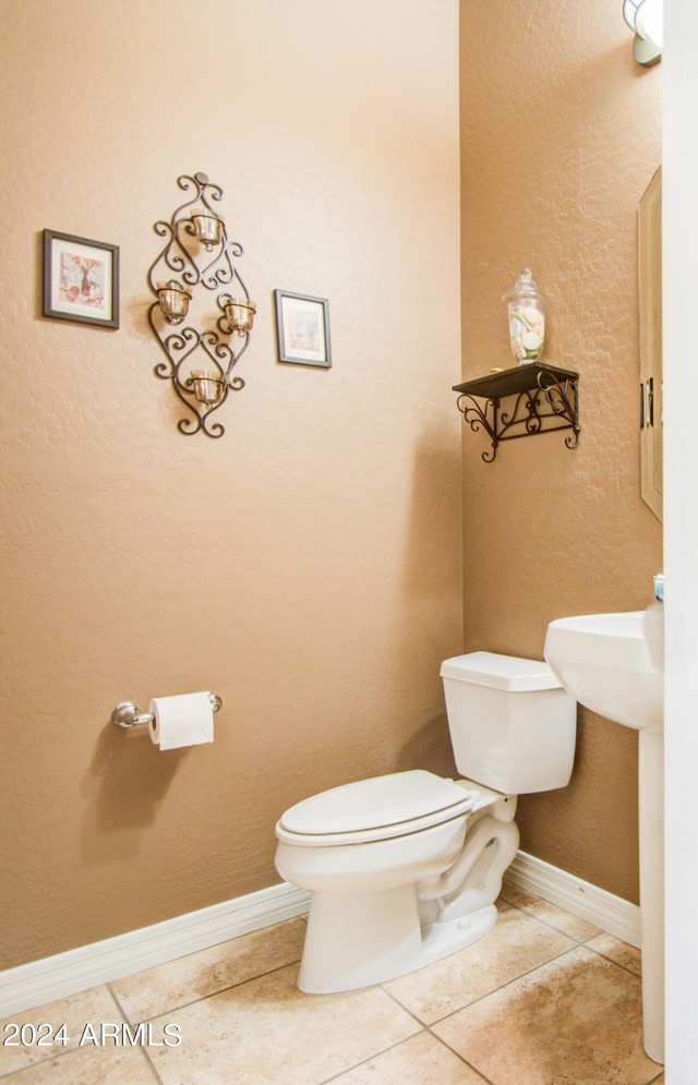 bathroom featuring tile patterned flooring and toilet