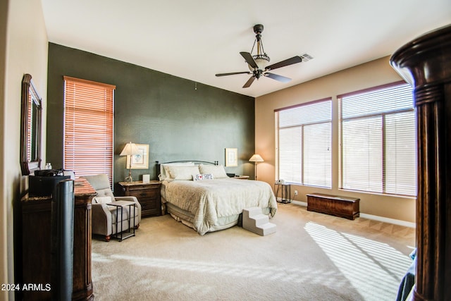 bedroom with light carpet and ceiling fan