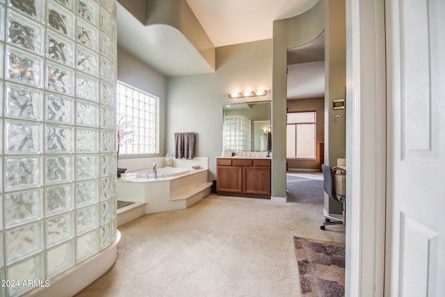 bathroom with a bathing tub and vanity