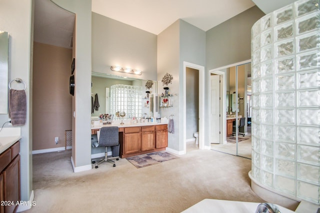 bathroom featuring vanity and a towering ceiling