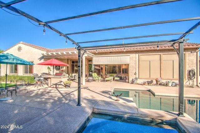 rear view of property with a pergola and a patio area