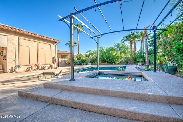 view of pool with an in ground hot tub, a pergola, and a patio area