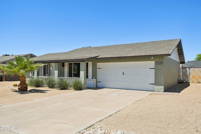 13842 N 40th Ave, Phoenix, AZ 85053 - single story home featuring covered porch, a garage, driveway, roof with shingles, and brick siding