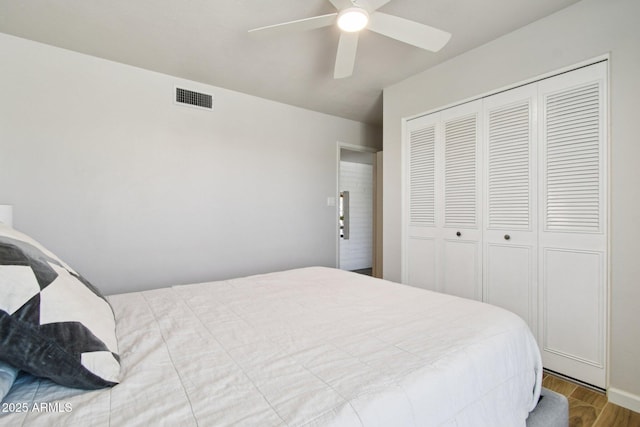 13842 N 40th Ave, Phoenix, AZ 85053 - bedroom featuring a closet, wood finished floors, and a ceiling fan