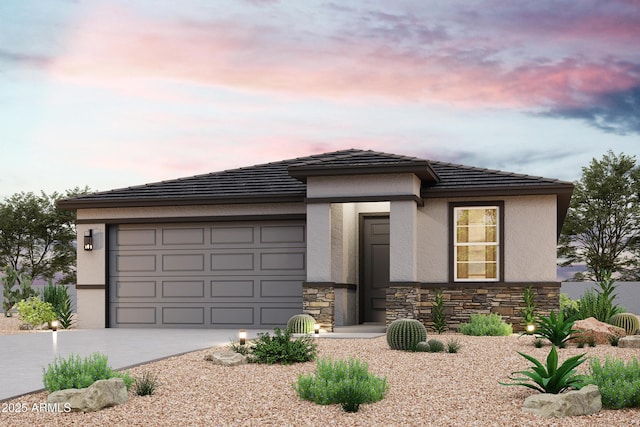 prairie-style house featuring concrete driveway, a tile roof, stucco siding, stone siding, and an attached garage