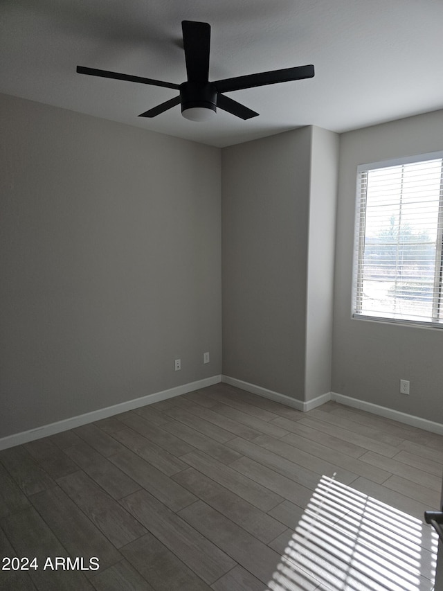 spare room featuring hardwood / wood-style flooring and ceiling fan