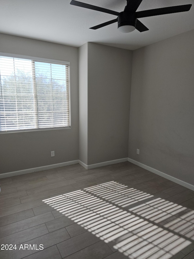 spare room with hardwood / wood-style flooring and ceiling fan