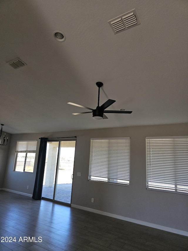 unfurnished room featuring ceiling fan and dark hardwood / wood-style flooring