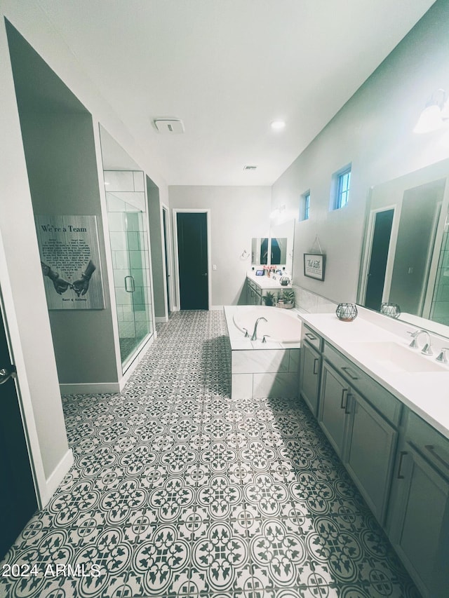 bathroom with tile patterned flooring, vanity, and independent shower and bath