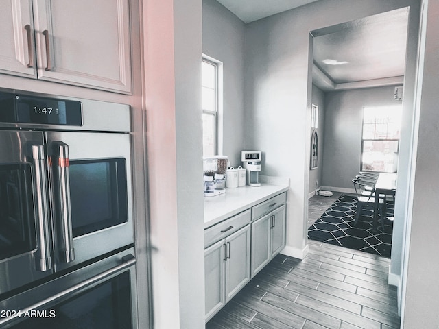 kitchen with double oven and white cabinets