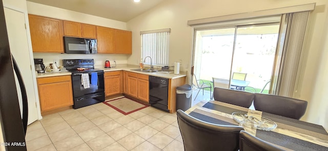 kitchen featuring sink, light tile patterned floors, vaulted ceiling, and black appliances