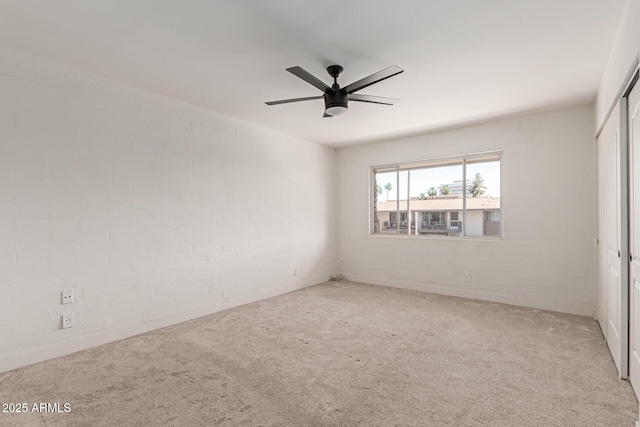unfurnished bedroom with a closet, carpet floors, and a ceiling fan