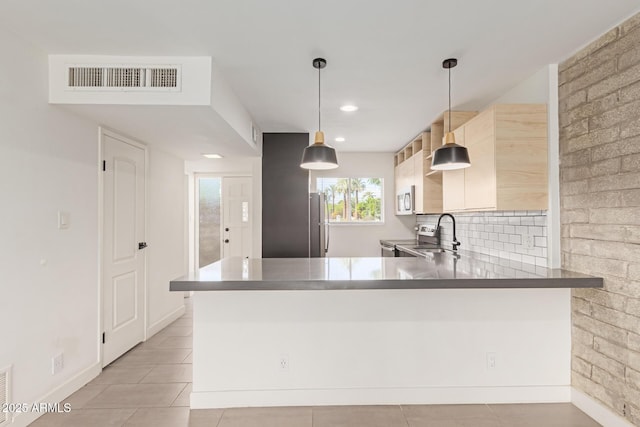 kitchen featuring stainless steel appliances, a peninsula, light tile patterned flooring, pendant lighting, and recessed lighting