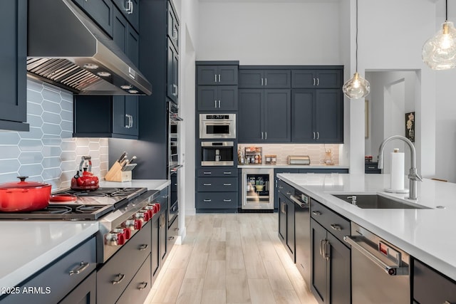 kitchen featuring decorative backsplash, sink, and hanging light fixtures