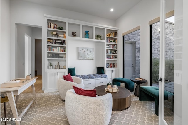 sitting room featuring built in shelves and french doors