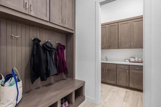 mudroom featuring light wood-type flooring and sink