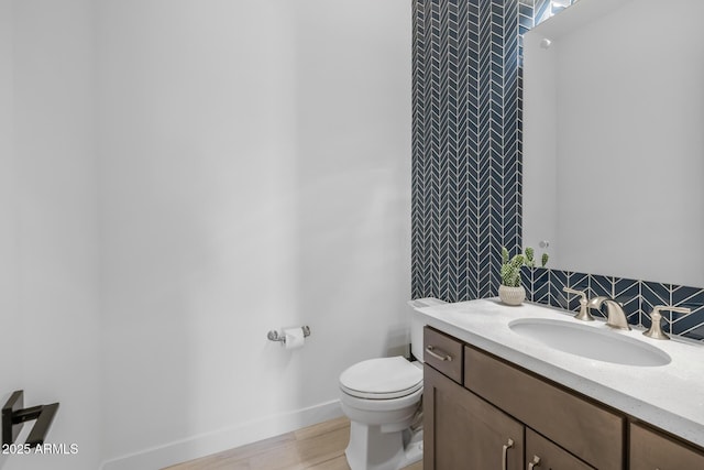 bathroom with vanity, toilet, and wood-type flooring