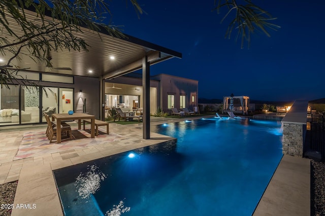 pool at twilight with a patio