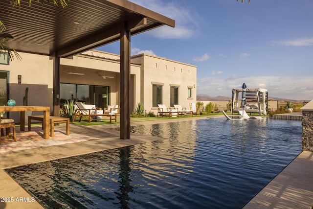 view of pool with a water view and a patio area