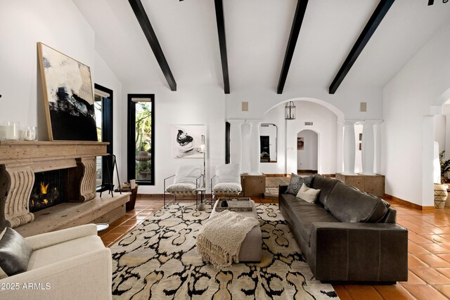 living room featuring tile patterned flooring, a high end fireplace, and high vaulted ceiling