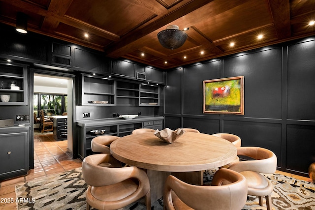 dining area featuring beamed ceiling, built in shelves, wooden ceiling, and coffered ceiling